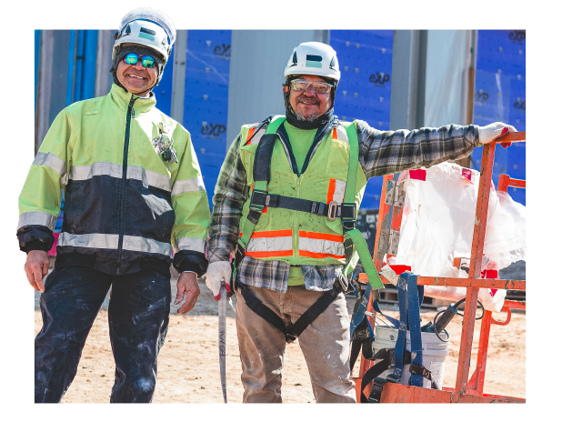 Two Branch Builds workers smile for camera, wearing safety gear